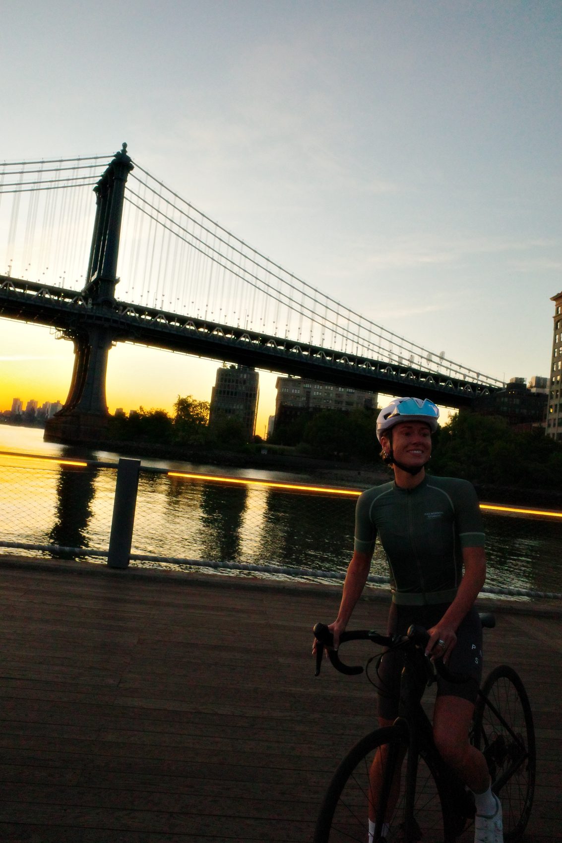 A Fools in Paradise rider at golden hour beside the bridge