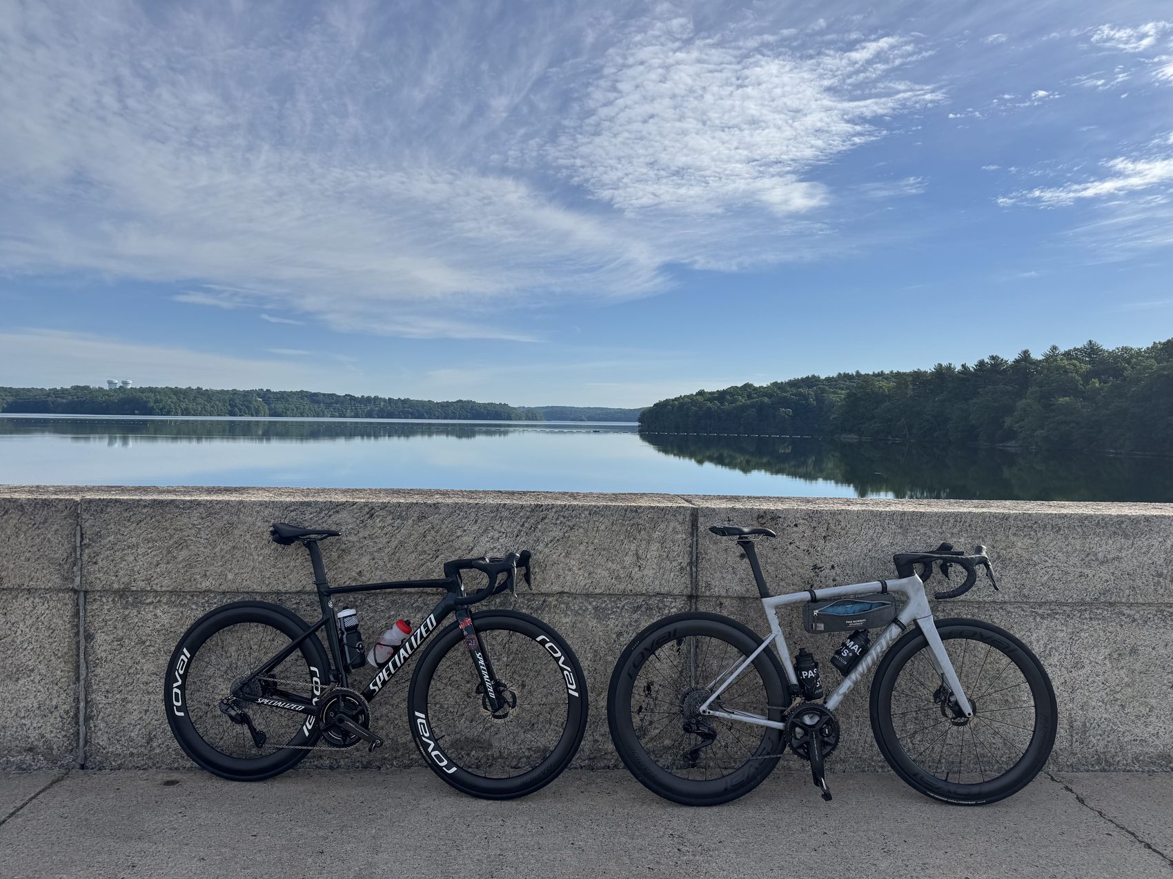 Two road bikes resting by the water on a Fools in Paradise ride